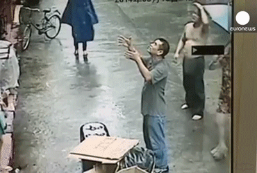 1540104720_5766_chinese_street_vendor_saves_baby_falling_out_of_a_building_dr_heckle_funny_wtf_gifs.gif